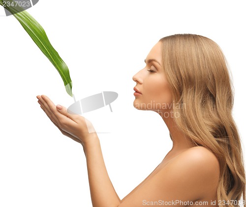 Image of woman with green leaf