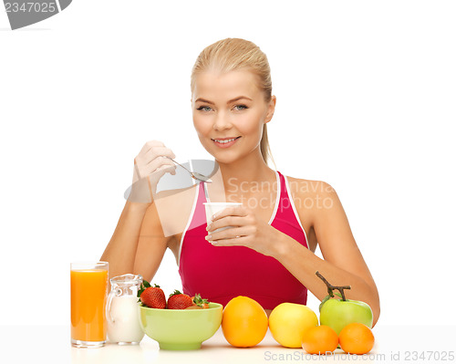 Image of young woman eating healthy breakfast