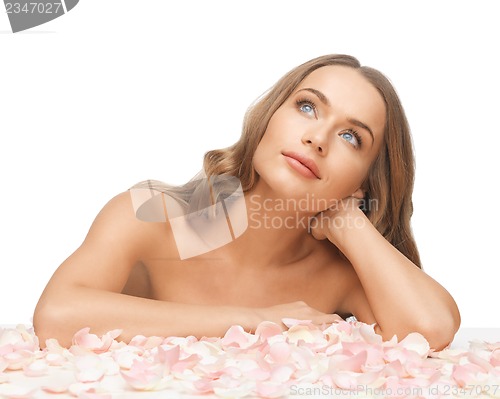 Image of beautiful woman with rose petals