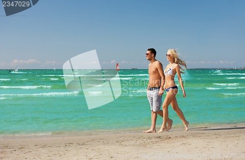 Image of couple walking on the beach