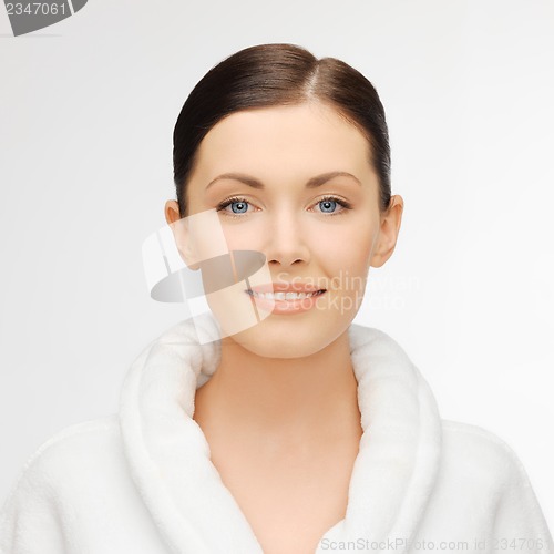 Image of beautiful woman in white bathrobe