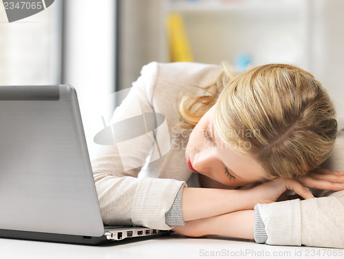 Image of bored and tired woman sleeping on the table