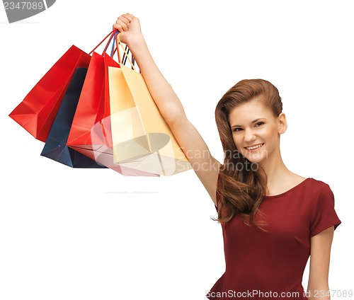 Image of teenage girl in red dress with shopping bags
