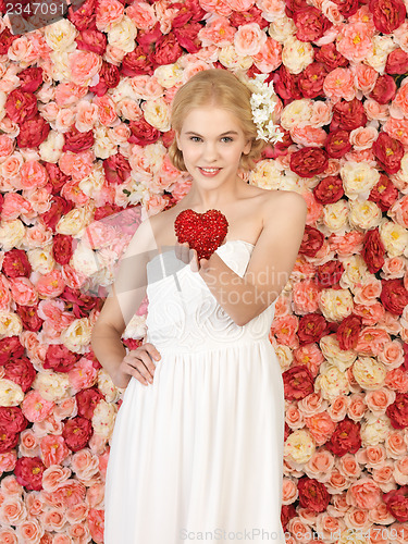 Image of woman with heart and background full of roses