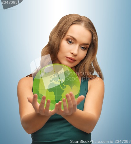 Image of woman holding green globe on her hands