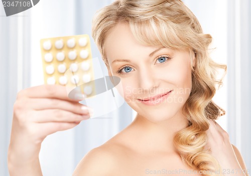 Image of young woman with pills