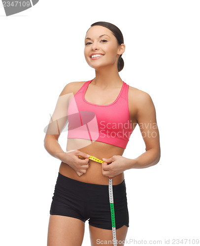 Image of sporty woman with measuring tape