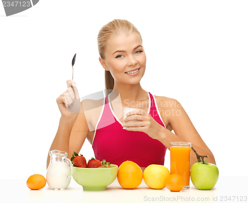 Image of young woman eating healthy breakfast