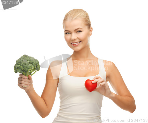 Image of woman holding heart symbol and broccoli