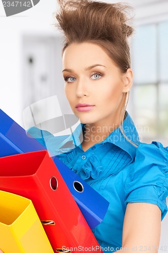 Image of serious woman with folders