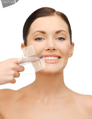 Image of beautiful woman pointing to teeth