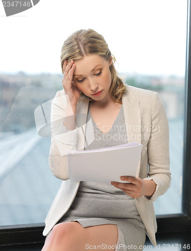 Image of bored and tired woman with documents