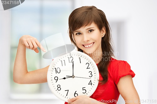 Image of teenage girl holding big clock