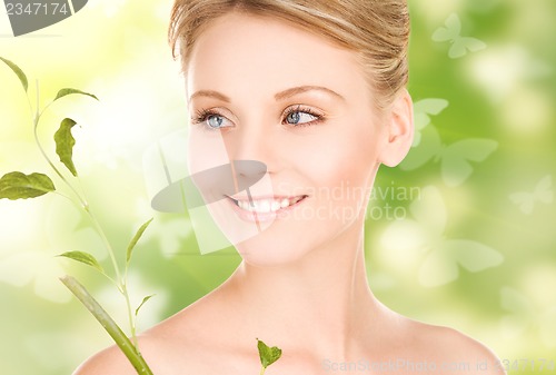 Image of woman with sprout and butterflies