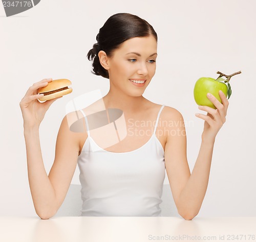 Image of woman with hamburger and apple