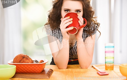 Image of young attractive woman in the kitchen