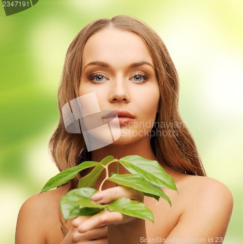 Image of woman with green leaf