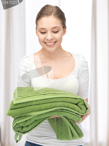 Image of lovely housewife with towels