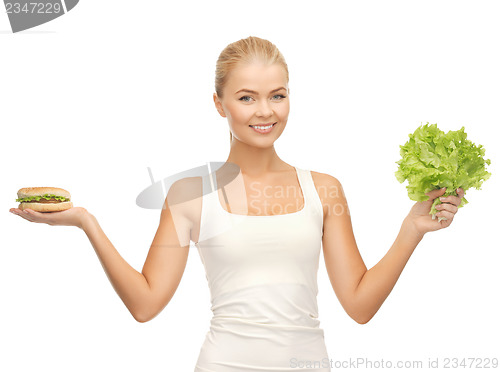 Image of woman with green lettuce and hamburger