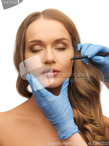 Image of woman face and beautician hands