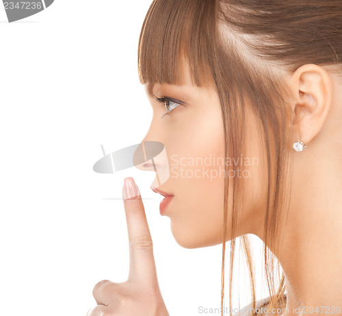 Image of happy woman with finger on lips