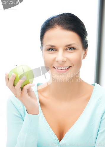 Image of beautiful woman in the with an apple