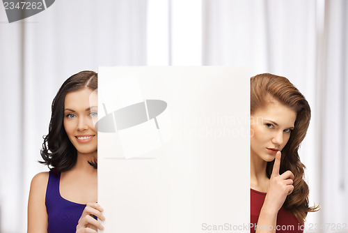 Image of two women with blank board