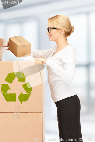 Image of attractive businesswoman with big boxes