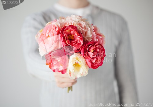 Image of man giving bouquet of flowers