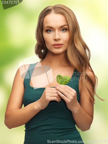 Image of woman with spinach leaves