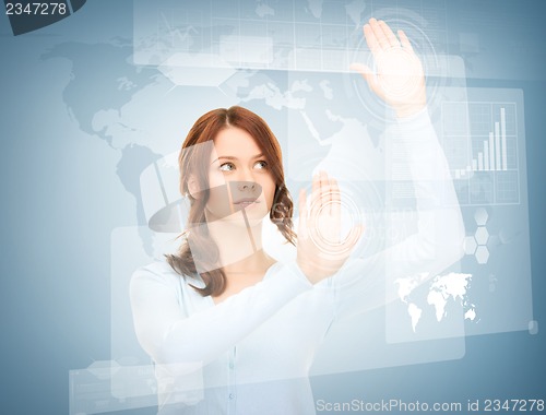 Image of businesswoman touching virtual screen