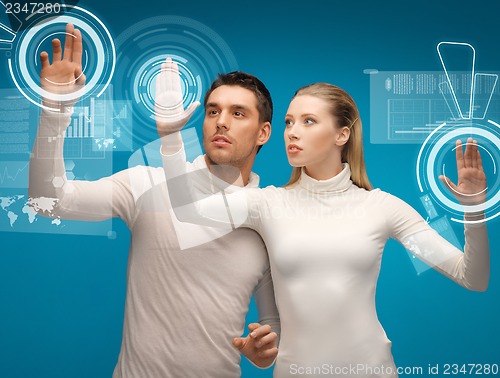 Image of man and woman working with virtual screens