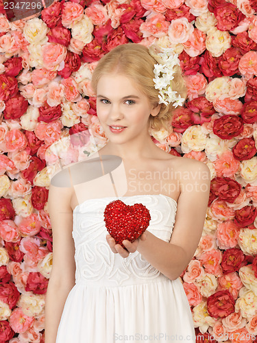 Image of woman with heart and background full of roses