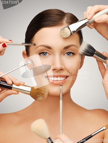 Image of beautiful woman with brushes