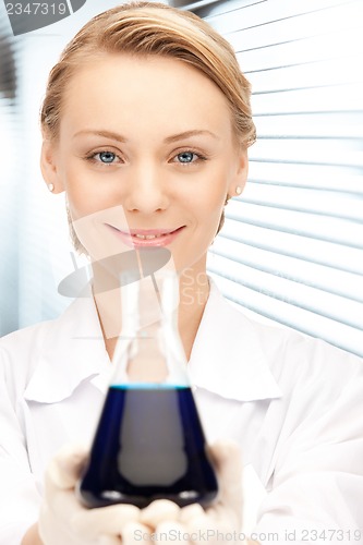 Image of lab worker holding up test tube