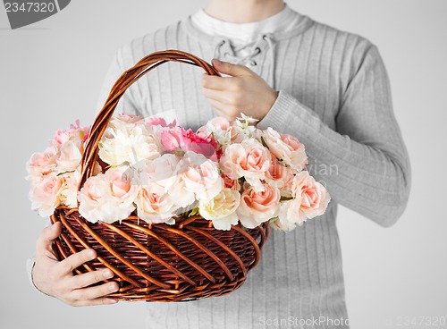 Image of man holding basket full of flowers