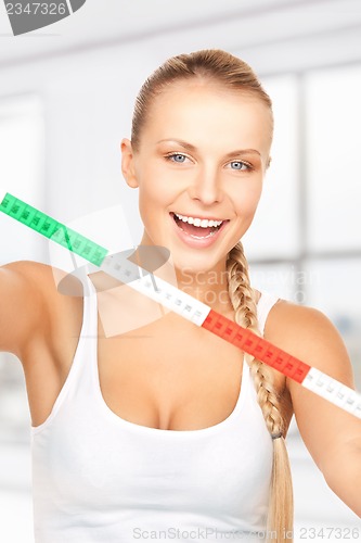 Image of young beautiful woman with measure tape