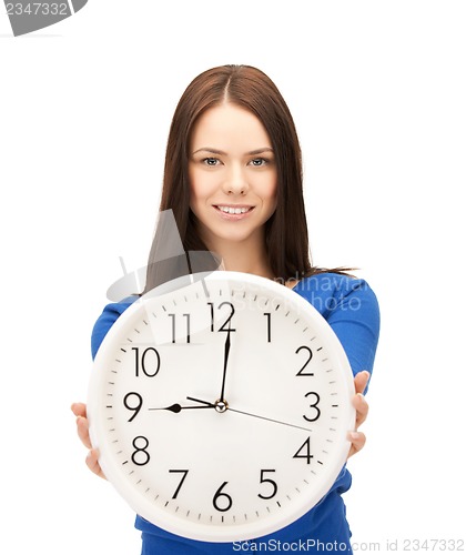 Image of businesswoman with wall clock