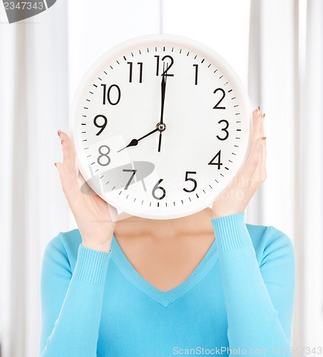 Image of businesswoman with clock over her face