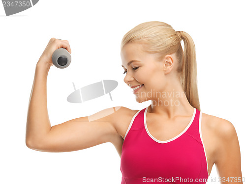 Image of young sporty woman with light dumbbell