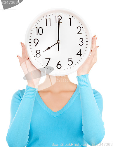 Image of woman holding big clock