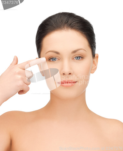Image of beautiful woman touching her eye area