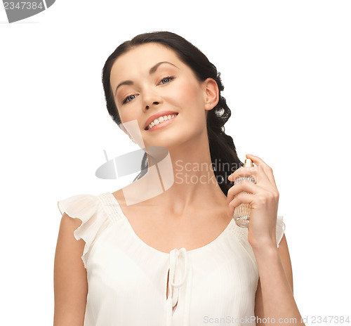 Image of woman spraying pefrume on her neck