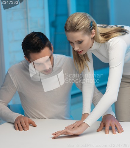 Image of man and woman working with something