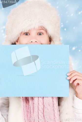 Image of girl in winter hat with blank board