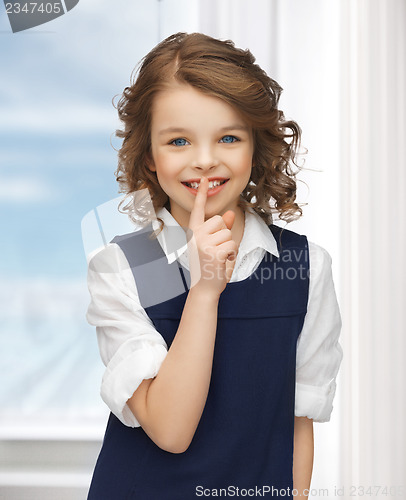 Image of pre-teen girl showing hush gesture