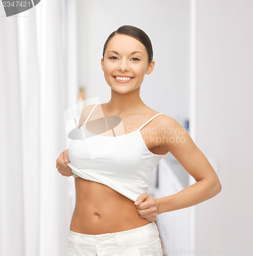 Image of woman taking off blank white t-shirt