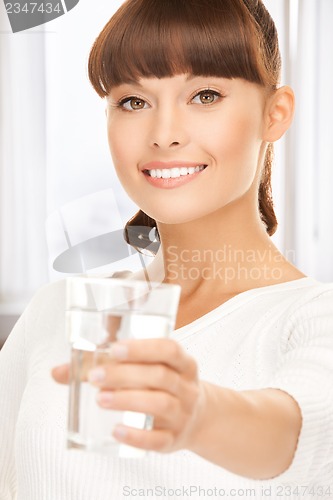 Image of young smiling woman with glass of water