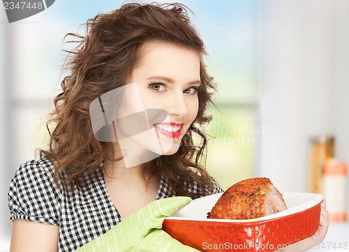 Image of housewife serving dish with meat