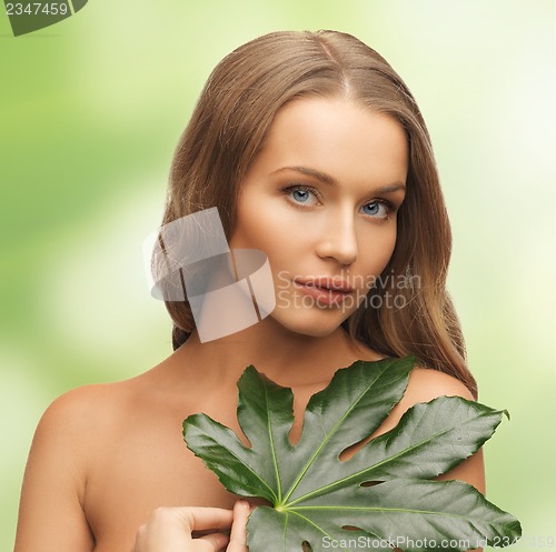 Image of woman with green leaf